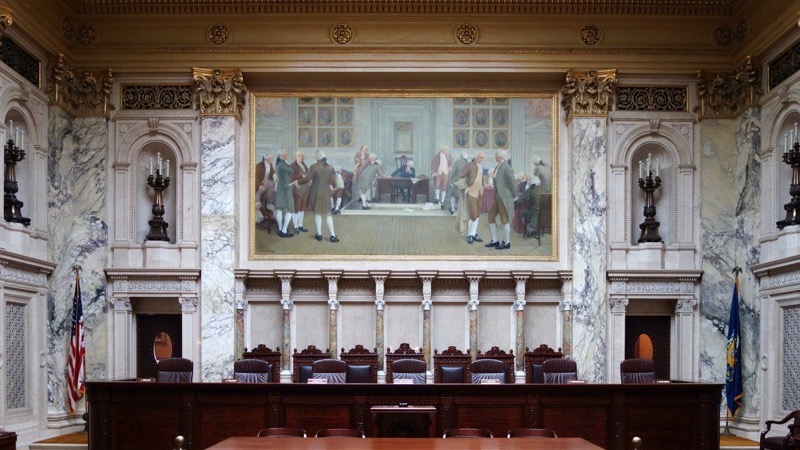 An empty witness box in a quiet courtroom before a hearing