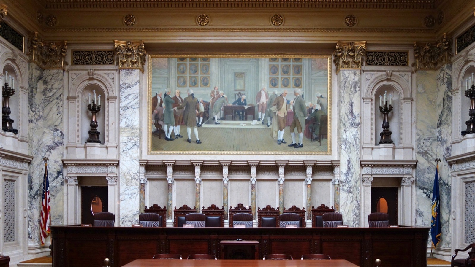 An empty witness box in a quiet courtroom before a hearing