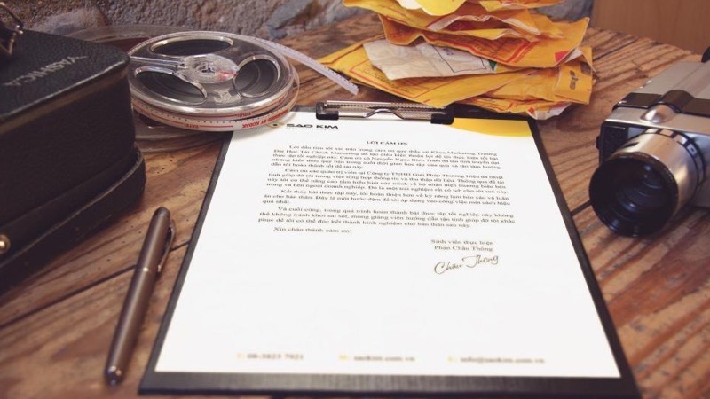 A lawyer reviewing a stack of legal documents at a desk with a pen.
