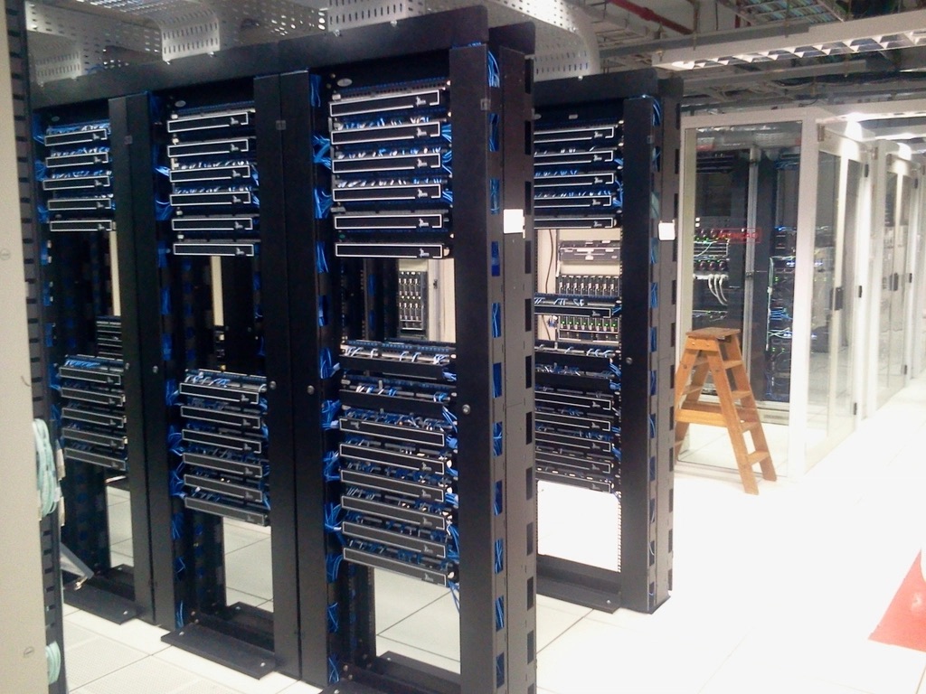 Server racks in a data center with organized cable management and indicator lights